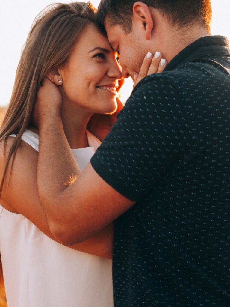 a happy couple embraces and looks into each others eyes