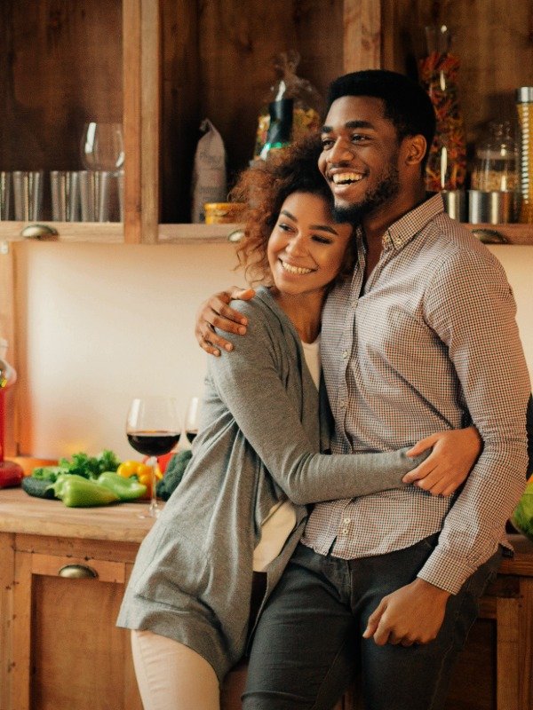 premium-match-package a smiling couple embraces in a kitchen during a party